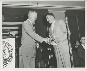 Bruce Barton shaking hands with client at Institute Day