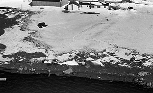 Aerial view of buildings and snowfield by coast