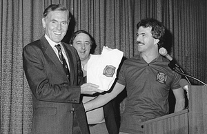 Mayor Raymond L. Flynn presenting award to unidentified man at Boston Arson Seminar