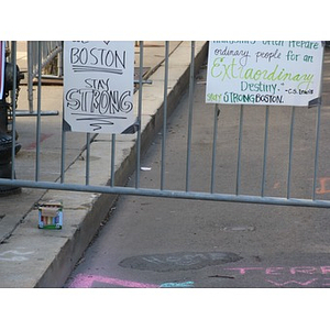 Signs and chalk messages at Boston Marathon memorial in Copley Square