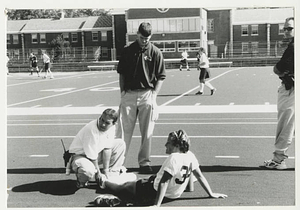 Athletic Trainer tending to Field Hockey player