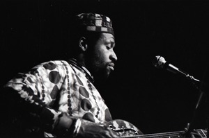 Taj Mahal in concert at Northfield, Mass.: Taj Mahal seated, playing steel guitar