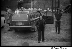 Doug Parker, Raymond Mungo, and Steve Diamond (l. to r.) with a Volvo station wagon, Montague Farm commune