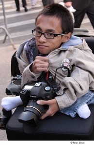 Occupy Wall Street: demonstrator in a wheel chair, holding a camera