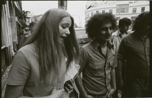 Abbie Hoffman walking in Harvard Square, talking with young woman (Church of the Final Judgment)