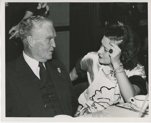 Bruce Barton and woman in apron at Thanksgiving dinner
