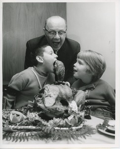 Dr. DiMichael and young clients with cooked turkey