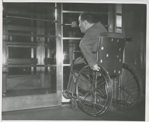 Man in a wheelchair entering a building