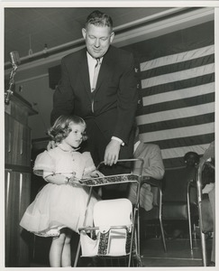 Little girl with stroller and man