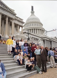 Congressman John W. Olver with group of visitors, posed on the steps of the United States Capitol building