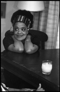Toni Cade Bambara: seated at a table