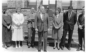 Mayor Raymond L. Flynn and a group of people listening to Massachusetts State Treasurer Robert Q. Crane speak