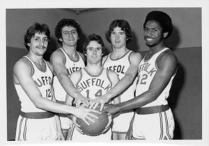 Suffolk University men's basketball players holding basketballs, 1976