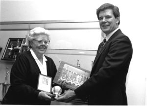 Suffolk University Law School Librarian and alumnus Patricia I. Brown donating items related to her career in the All-American Girl's Professional Baseball League to Athletics Director James E. Nelson (1978-2013)