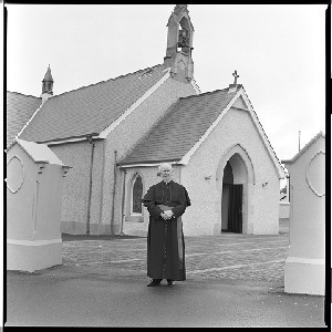 Canon Bernard Magee outside his Church