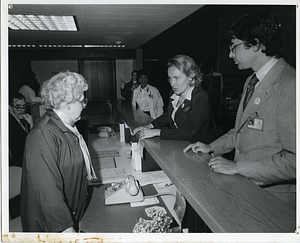 [Kathryn White with two unidentified people at hospital desk]