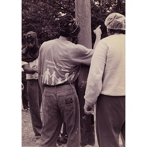Men preparing to scale the greased pole at the Festival Betances' Greased Pole Contest.