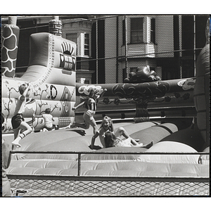 Children play on an inflatable at a carnival