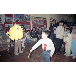 Boy takes a swing at a piñata