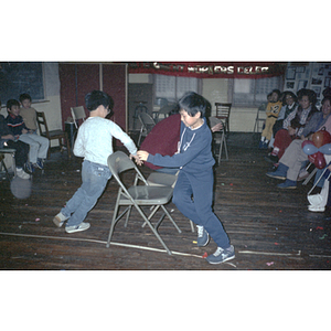 Children play musical chairs at a Garment Workers' Center event