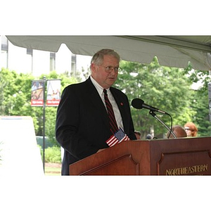 Neal Finnegan stands at the podium at the Veterans Memorial groundbreaking ceremony