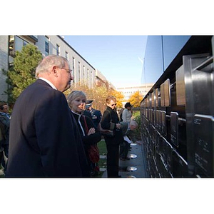 Neal Finnegan and others look at the Veterans Memorial at the dedication ceremony