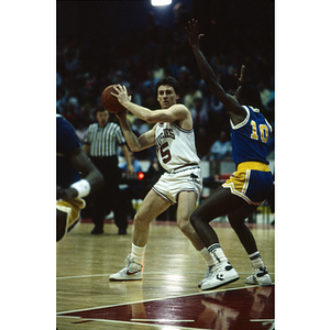 Northeastern men's basketball player about to pass the ball