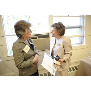 Two women talk at the groundbreaking ceremony for the George J. Kostas Research Institute for Homeland Security