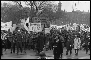 Anti-war protesters marching at the Counter-inaugural demonstrations, 1969, with banners and signs: 'Down with the racist brass,' 'GI's for Peace'