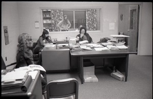 Unidentified person, Darlene Cobleigh, Bruce Geisler (behind glass), and Mike Scanlon (l. to r.) in office