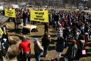 Protesters listening to a speaker: rally and march against the Iraq War