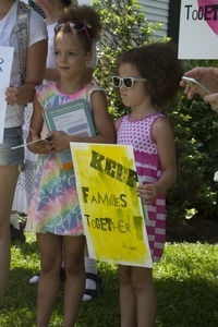 Young girls with signs at the pro-immigration rally in front of the Chatham town offices building : taken at the 'Families Belong Together' protest against the Trump administration's immigration policies
