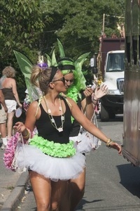 Parade marchers with green fairy wings and tutus : Provincetown Carnival parade