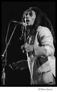 Bob Marley in concert, signing at the microphone