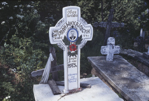 Closeup of cross in Volce churchyard