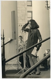 Young woman addressing the crowd at an anti-Vietnam War protest on the steps of the First Congregational Church