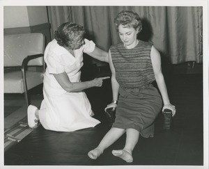 Physical therapist assisting Mrs. Frances Marsala in her exercises