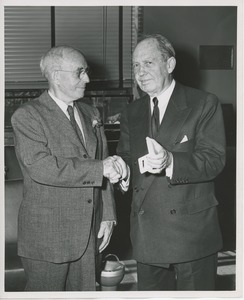 Jeremiah Milbank, Sr. shaking hands with retiring employee