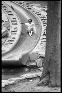 Child descending a slide at a playground