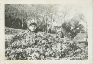 Paul Kahn and his sister Sharon in a pile of leaves
