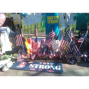 Photograph of a Boston temporary memorial with "Boston Strong" posters and American flags