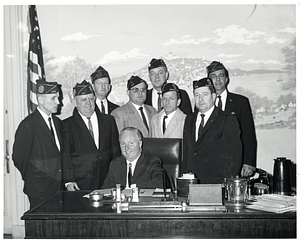 Massachusetts State Comptroller Joseph Alecks, Chief Marshal Charles B. Peck, Alfred T. Duncan, Victor B. Kossner, Edward L. Keluirtas, Paul L. Rogers, Joseph W. Walker, Edward L. Connelly, and Mayor John F. Collins in his office