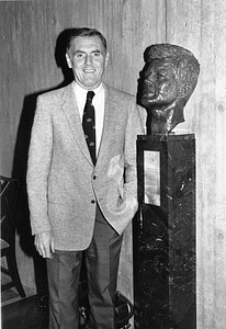 Mayor Raymond L. Flynn next to bust of President John F. Kennedy