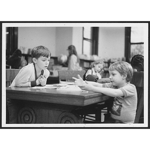 Children working at tables inside Hyde Park branch