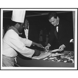 Chef serving food to staff at event