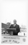 Central Artery/Third Harbor Tunnel groundbreaking ceremony, John Joseph Moakley speaking behind podium and Massachusetts Department of Public Works sign
