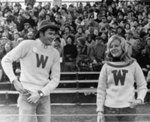 A male and female cheerleader at a Weston hall football game, 1969