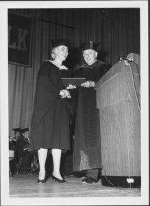 Registrar Mary Heffron receives degree from President John E. Fenton (1965-1970) at the 1967 Suffolk University Commencement
