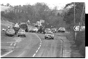 Loyalist Day of Action against the Anglo-Irish Agreement. Tractor cavalcade outside Carryduff, Belfast. Includes shots of Rev. Ian Paisley, leader of the DUP driving a tractor and waving a Union Jack