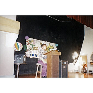 Boy at the podium addressing the audience at a Teen Empowerment Program event at the Jorge Hernandez Cultural Center.